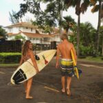 Surfers walking with boards